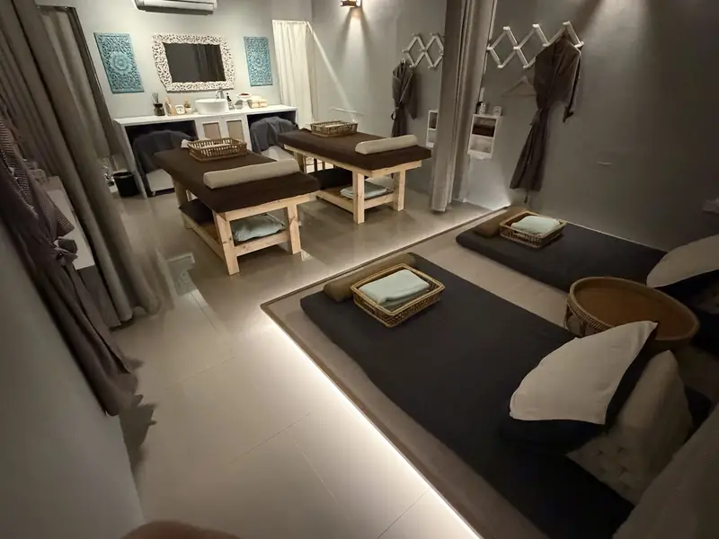 A treatment room for two with massage beds and floor mats for Thai massage