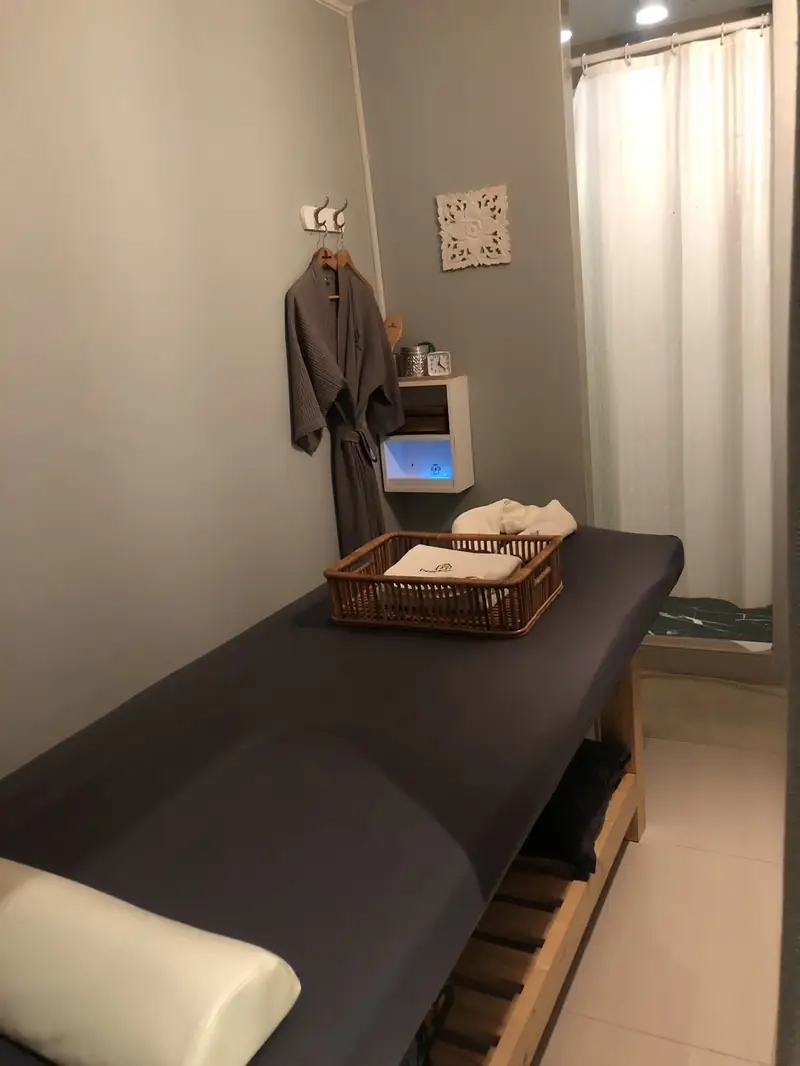 A private single treatment room with a robe and fresh towels
