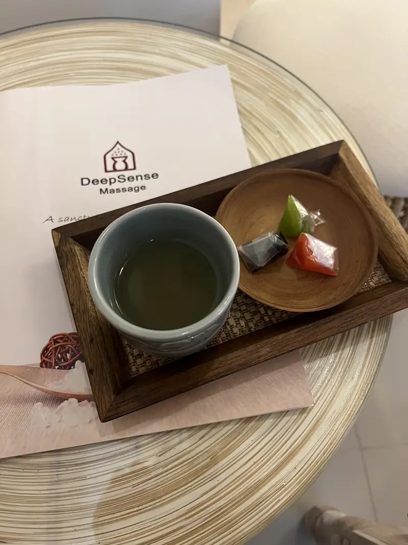 Tea and Thai sweets served on a wooden tray after the massage